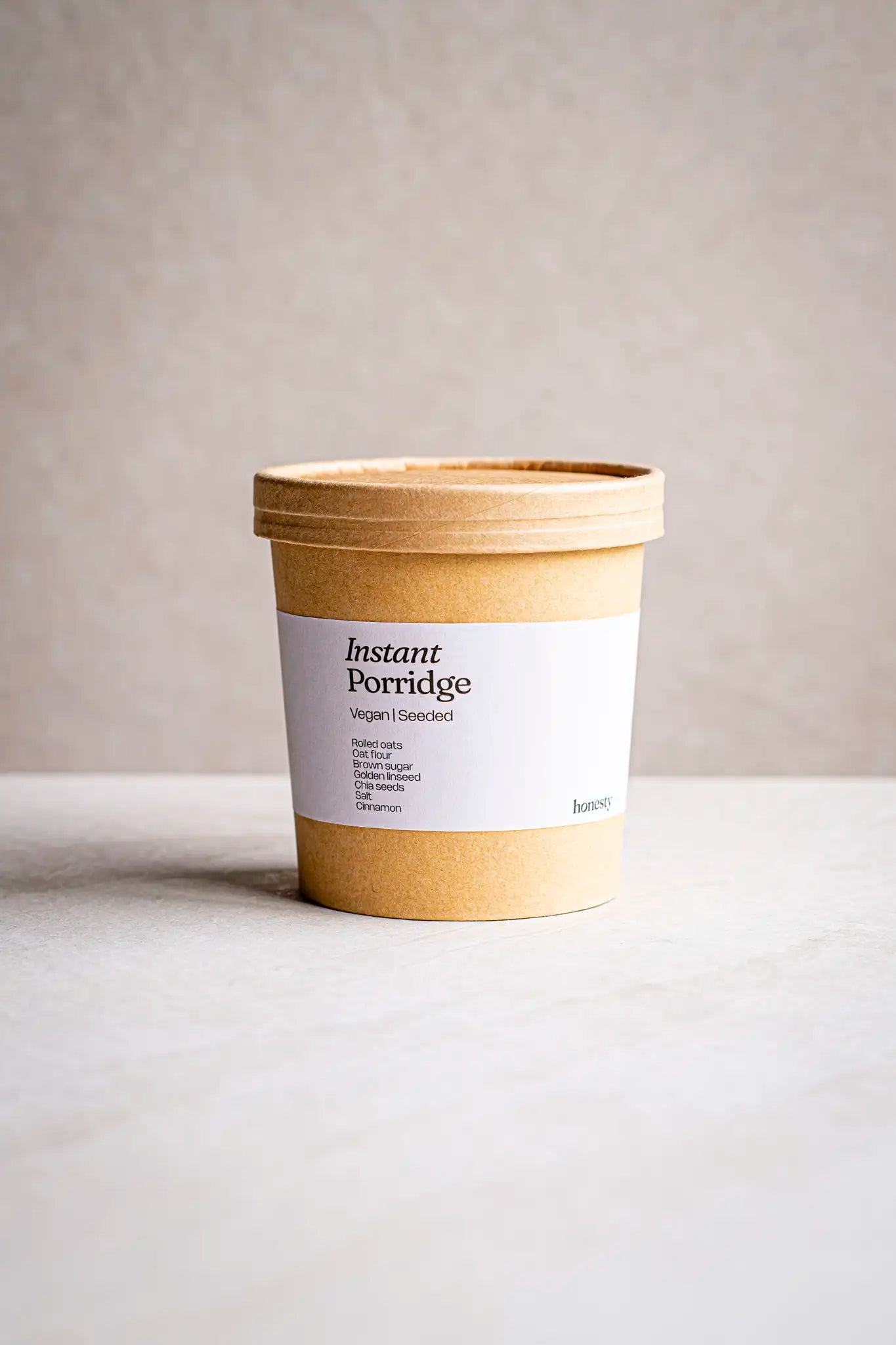 A brown cardboard container labeled Victoria Sponge by Honesty sits on a light surface against a neutral background. The label highlights its wholesome, handmade quality—ideal for fans of honest, artisanal treats.