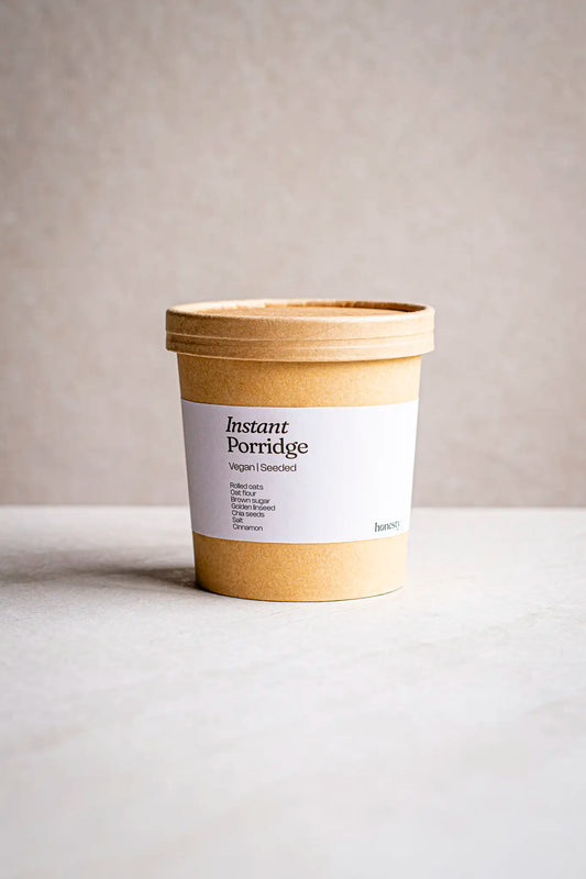 A brown cardboard container labeled Victoria Sponge by Honesty sits on a light surface against a neutral background. The label highlights its wholesome, handmade quality—ideal for fans of honest, artisanal treats.
